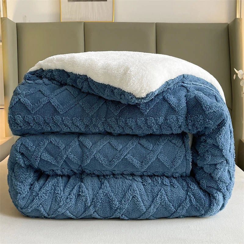 A serene bed elegantly covered with the Ocean Blue Weighted Blanket, highlighting its plush coral fleece texture that offers exceptional warmth and comfort. The soothing blue hue adds a calming element to the bedroom decor, creating a peaceful retreat. With its anti-pilling feature, this blanket promises long-lasting durability, perfect for cozy nights and restful sleep.