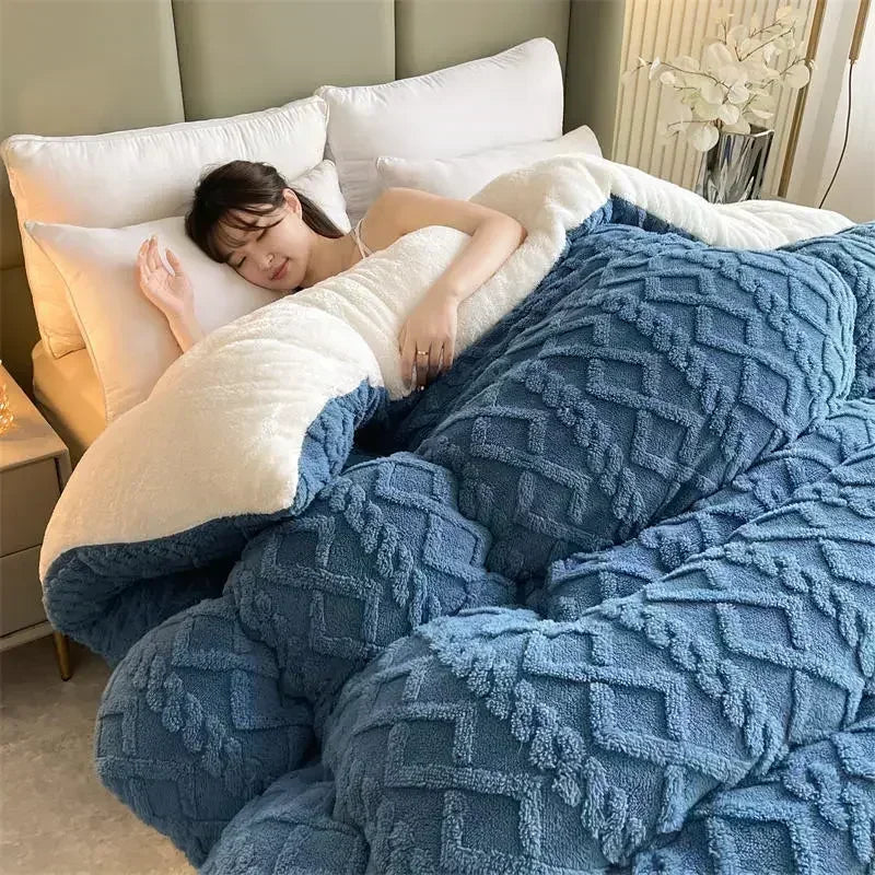 A serene bed elegantly covered with the Deep Ocean Blue Weighted Blanket, highlighting its plush coral fleece texture that offers exceptional warmth and comfort. The soothing blue hue adds a calming element to the bedroom decor, creating a peaceful retreat. With its anti-pilling feature, this blanket promises long-lasting durability, perfect for cozy nights and restful sleep.