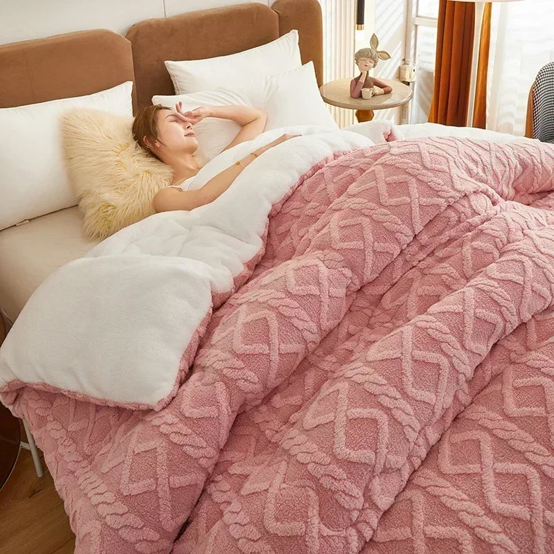 A stylish bed adorned with the Blush Pink Weighted Blanket, showcasing its luxurious coral fleece texture that provides exceptional warmth and comfort. The gentle pink hue adds a touch of elegance to the bedroom decor, while its anti-pilling feature ensures lasting beauty. Ideal for cozy nights in or adding a pop of color to any space.