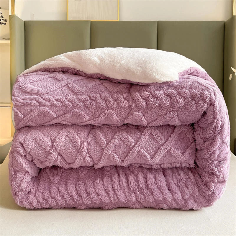 A beautifully arranged bed featuring the Lavender Dream Weighted Blanket, highlighting its soft coral fleece texture that offers unparalleled warmth. The calming purple shade enhances the bedroom's ambiance, creating a serene retreat. With its anti-pilling feature, this blanket combines style and durability, perfect for cozy evenings and restful sleep.