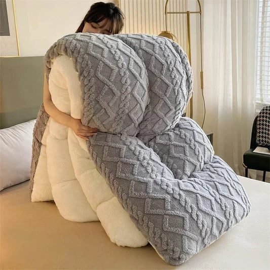 A person comfortably holding the Luxury Cashmere Weighted Blanket, showcasing its soft coral fleece texture and cozy design. The blanket is draped over their shoulders, highlighting its warmth and versatility, with a stylish interior backdrop to emphasize its luxurious appeal.