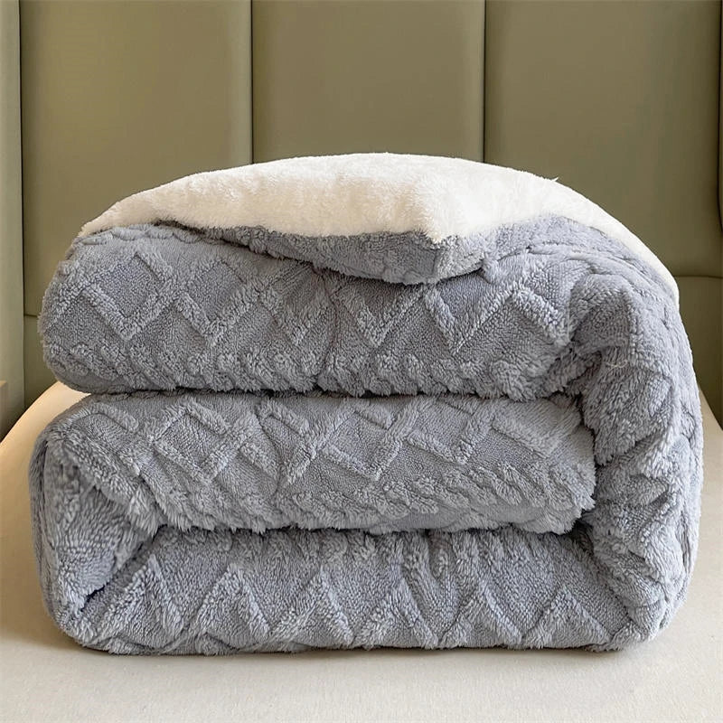 A modern bed dressed with the Slate Grey Weighted Blanket, showcasing its plush coral fleece fabric that provides exceptional warmth and coziness. The sophisticated grey tone adds a sleek, contemporary touch to the bedroom decor. Its anti-pilling feature ensures long-lasting durability, making it perfect for creating a chic and comfortable space.